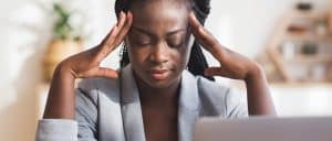 Hard work. Tired african american businesswoman suffering from migraine at workplace in office, panorama